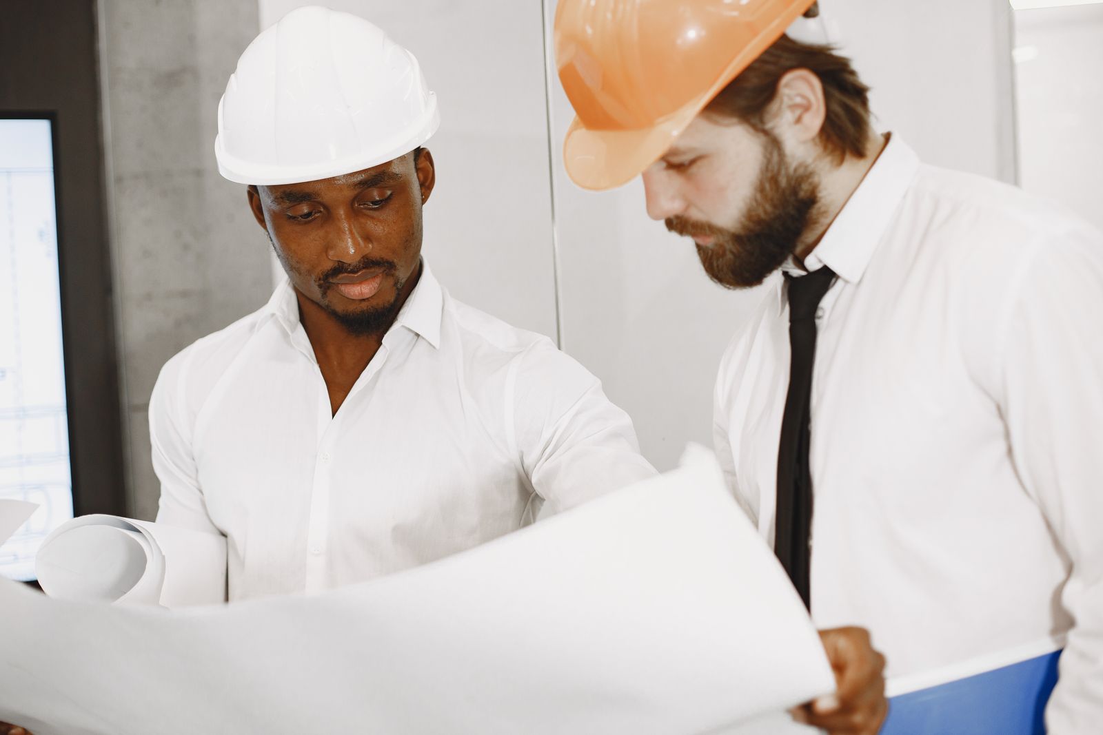 Engineers reviewing technical drawings